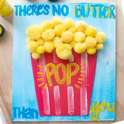Popcorn Craft 'There's no butter pop than you' painted on canvas as an example of father's day crafts for kids