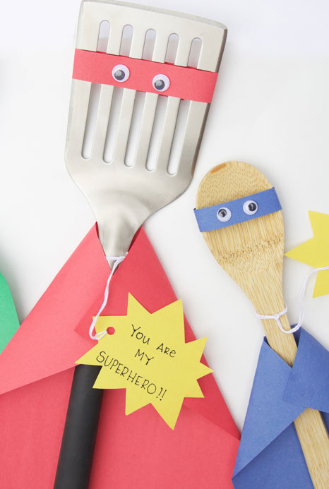 Super Hero Project A spatula and a spoon are decorated to look like superheroes as an example of father's day gifts for kids.