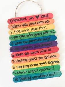 Popsicle-Stick-Craft Several rainbow popsicle sticks are stacked together with sweet messages written on them in this example of Father's Day kids crafts.