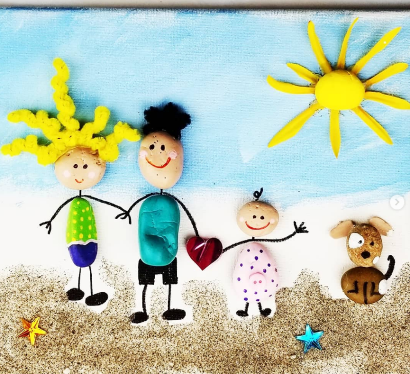 Rock-Family A mom, Dad, a child, and a dog are made from painted rocks as an example of Father's Day crafts for kids.