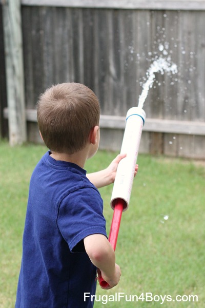 water-shooter child holding water shooter made with PVC pipe