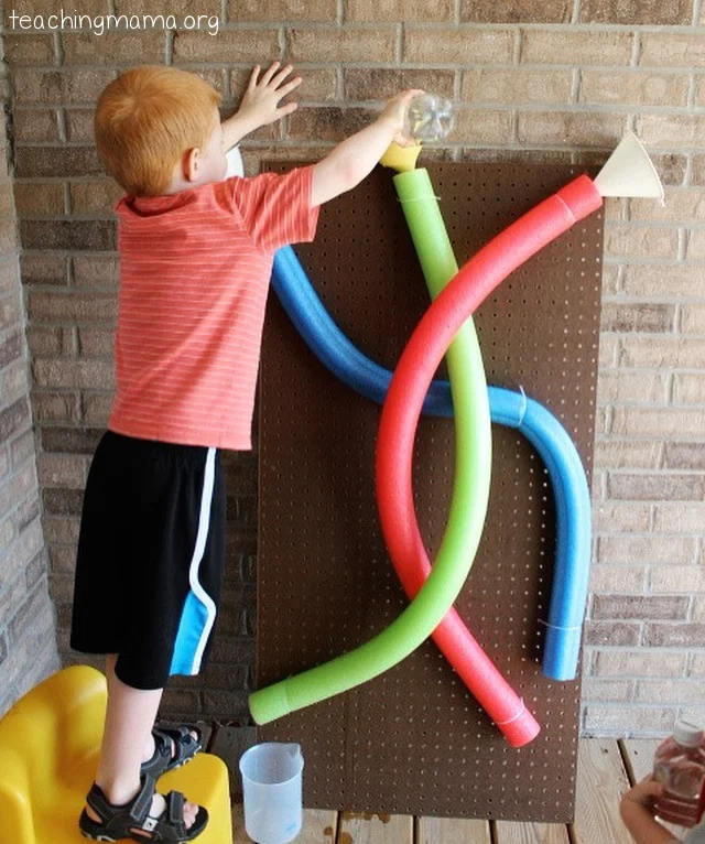 Water-Wall boy standing by a water wall made of pool noodles