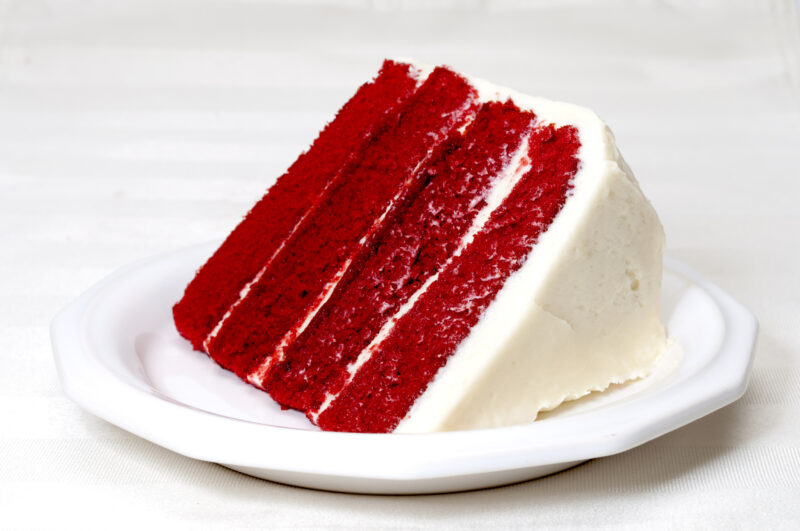 Red Velvet Cake Slice of red velvet cake on a place as an example of the tradition of eating red foods on Juneteenth.