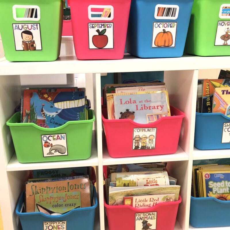 Colorful classroom library bins filled with books.