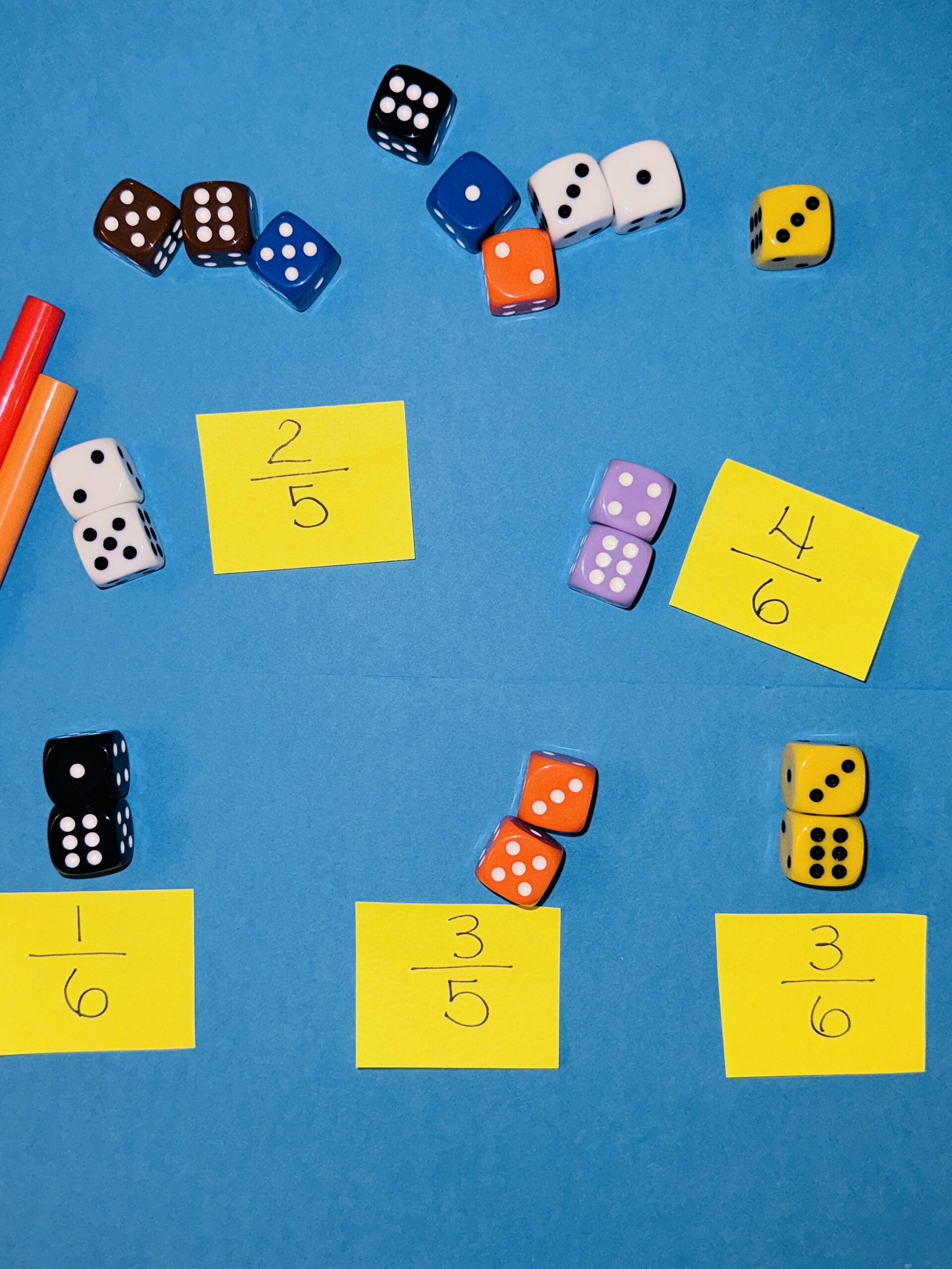 RollAFraction2 Dice laid out to represent parts of a fraction
