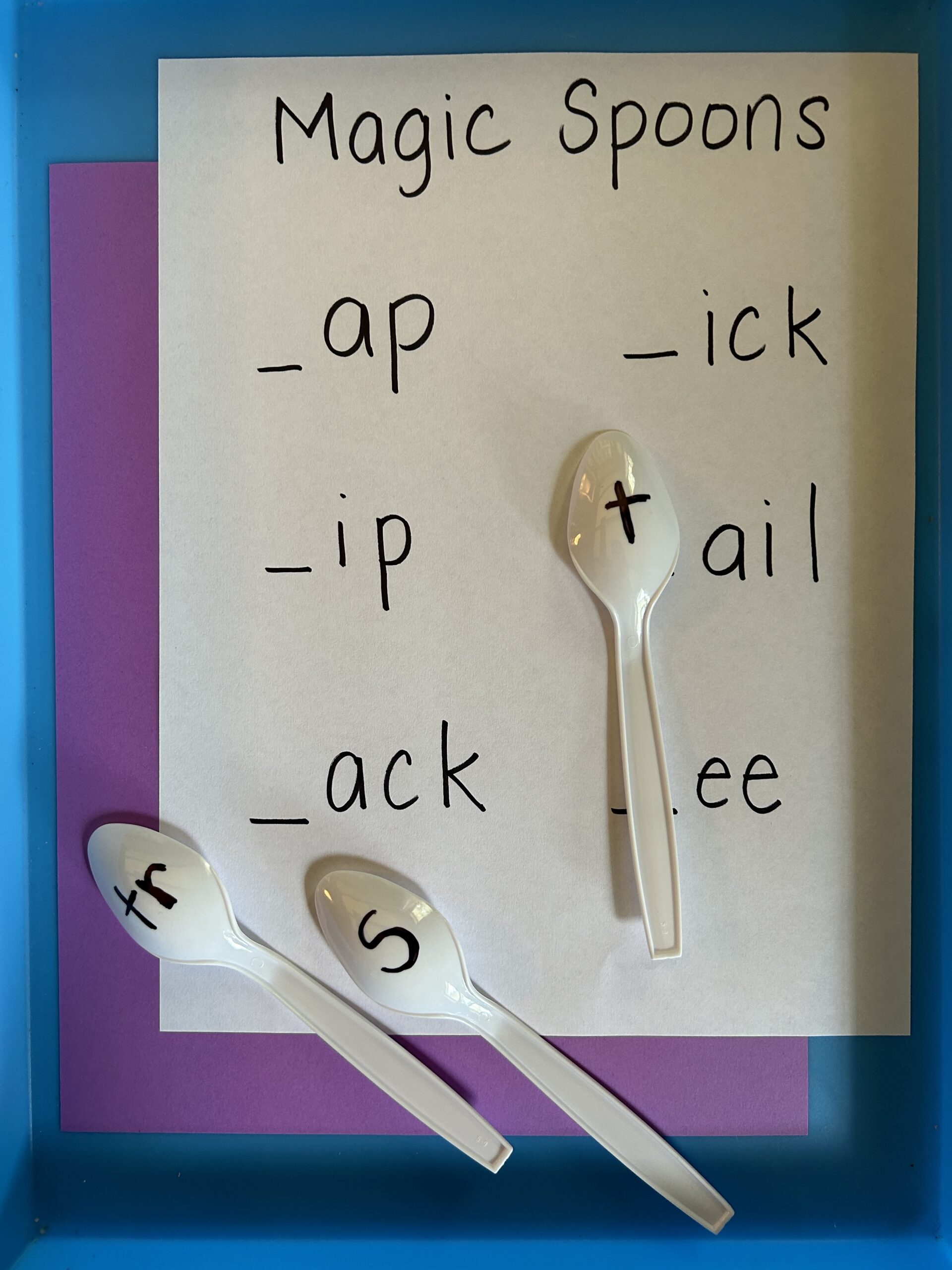 Make magic spoons by writing letters on plastic spoons.
