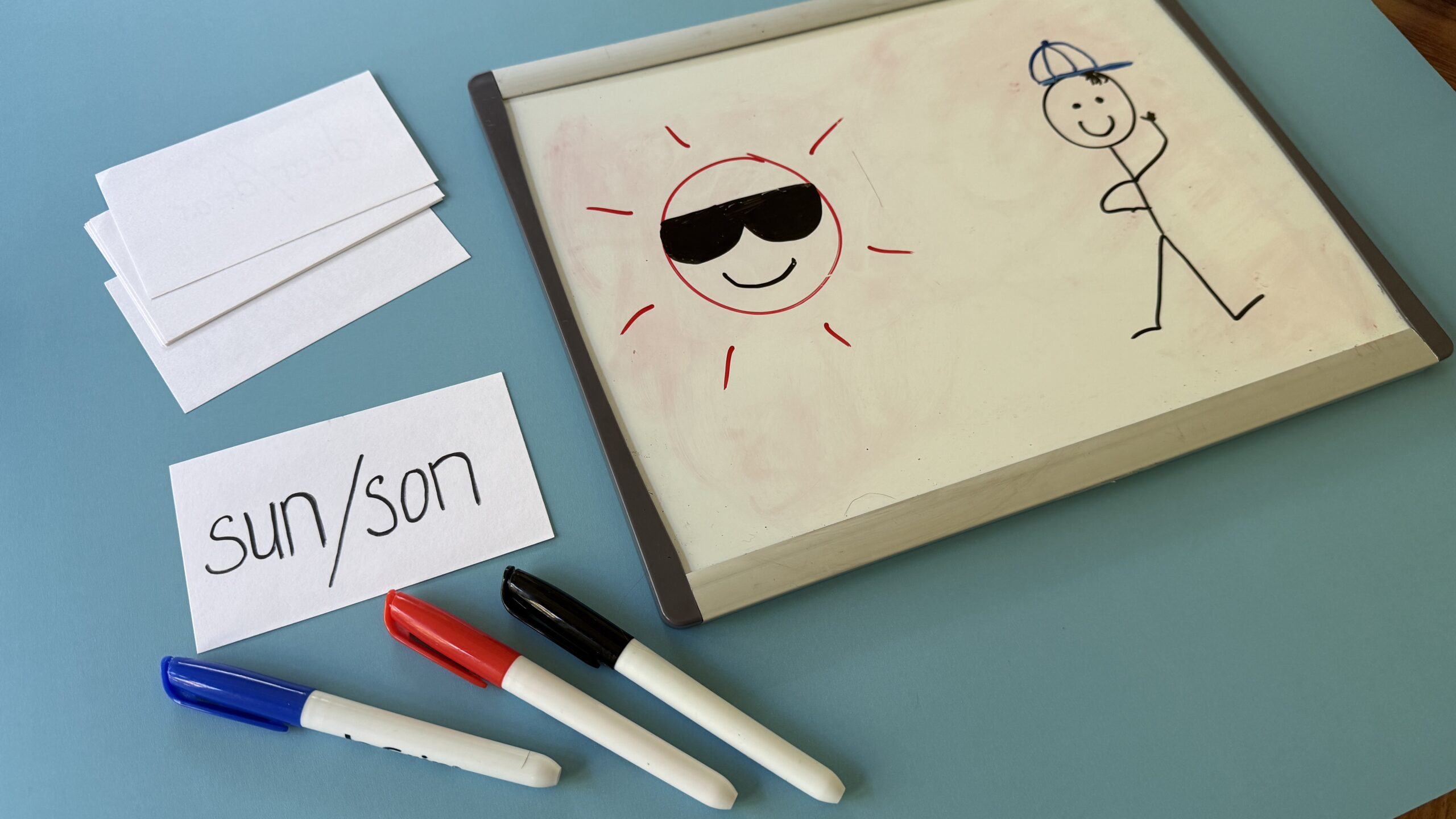 Homophone Pictionary with notepad of drawing of sun and stick figure
