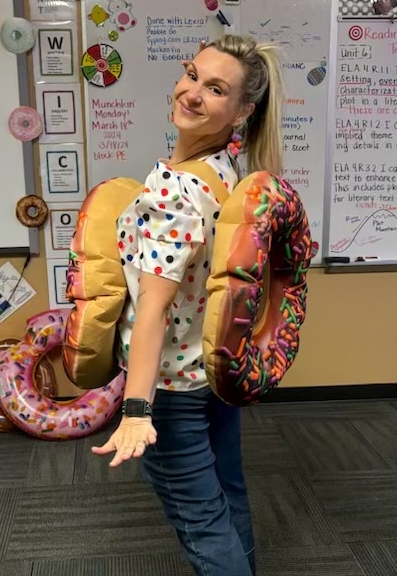 Halloween Costume: Arnie the Donut Teacher wearing a plush donut costume