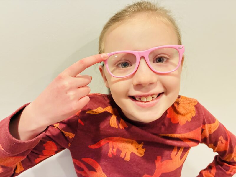 Five Senses Activities a student wearing pink glasses and pointing to them