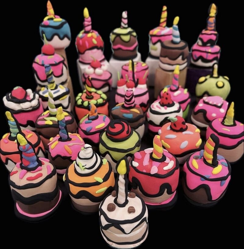 Miniature cakes made of clay with candles on top