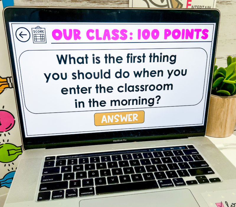 Laptop screen showing a slide with a question from a rules and routines trivia classroom management game